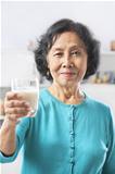 Senior woman holding glass of milk