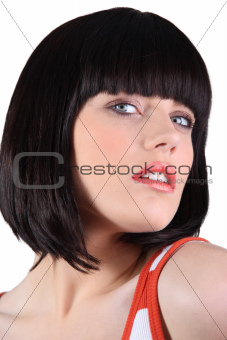 close-up portrait of glamorous blue-eyed brunette with fringe