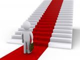 Businessman in front of stairs with red carpet
