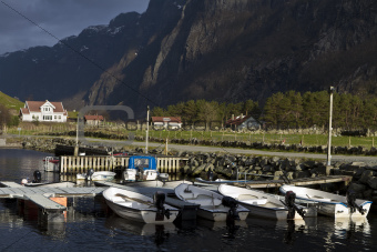 small harbor with mountains in background