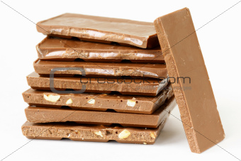 Chocolate bar with different toppings (nuts, yogurt) on a white background