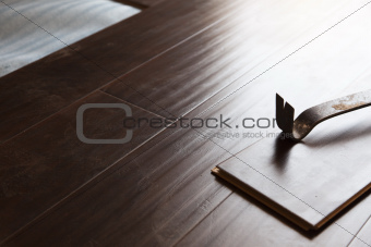 Pry Bar Tool with New Laminate Flooring Abstract.