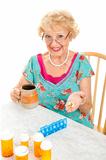 Smiling Senior Woman Takes Medicine
