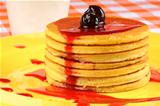 Pancakes with syrup and sour cherries