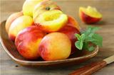 red ripe peaches on wooden table