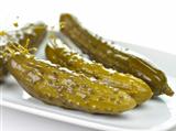 dill pickles on a white dish