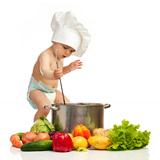Little boy with ladle, pot, and vegetables