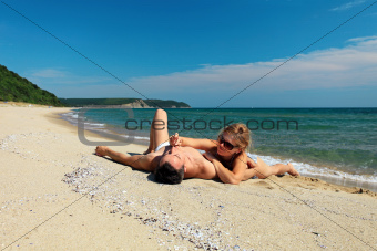 Young couple sunbathing at the beach