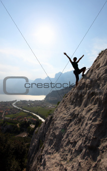 Female rock climber with outstretched arms