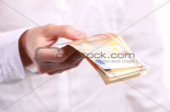 Female hand holding fifty euro banknotes