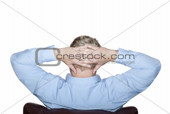 Man sitting on a chair with folded arms behind the head