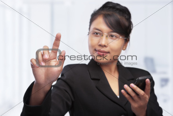 Asian businesswoman pointing or touching blank glass screen