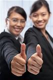 Two Asian businesswoman with thumbs up