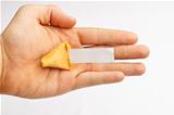 Half of a fortune cookie in a hand with a blank fortune