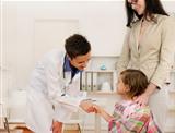 Pediatrician shaking hand with girl child patient