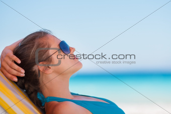 Relaxed woman laying on beach