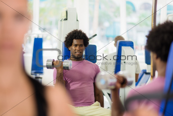 young people training and working out in fitness club