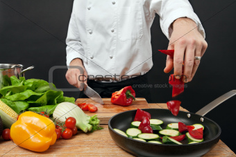 Chef adding ingredients