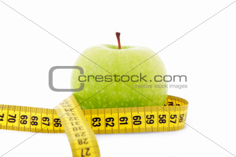 green apple with yellow measuring tape