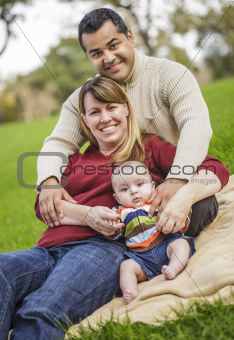 Happy Mixed Race Family Posing for A Portrait in the Park.