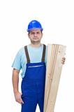 Worker in uniform holding wooden planks