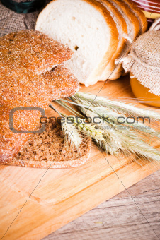 sliced bread and wheat on the wooden table