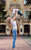  Happy young woman lifting her son high up