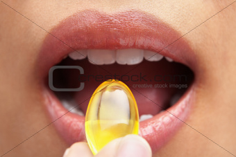 Woman mouth and capsule
