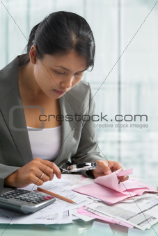 Asian bussinesswoman checking bills