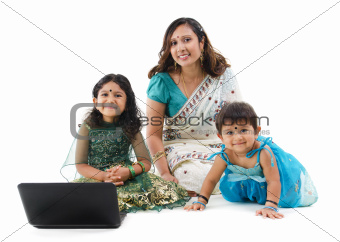 Traditional Indian family with laptop