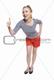 Portrait of a young woman showing thumbs up