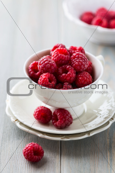 Fresh raspberries in a tea cup