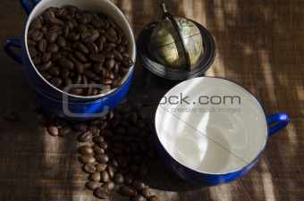Coffee Cups and Coffee Beans on Oak Surface with Small Globe