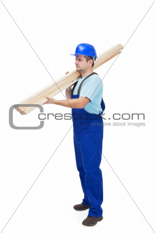 Worker carries wooden planks