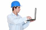 Man in a hardhat with a laptop