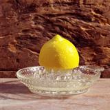 yellow lemon on a citrus squeezer