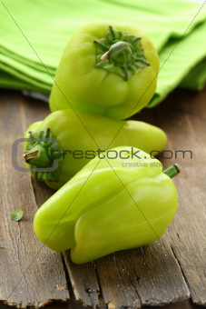 organic green peppers on a wooden table