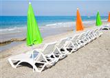 Beach chair and colorful umbrella on the beach
