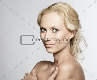 Portrait of pretty blonde woman with crossed arms