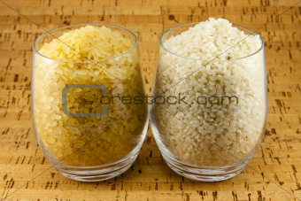 Two varieties of rice inside two transparent glasses