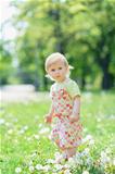 Baby on dandelions field