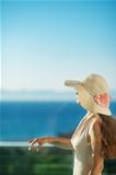 Woman looking on sea on balcony and relaxing