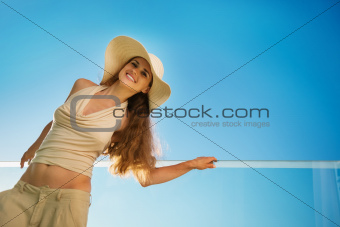 Smiling woman standing on balcony