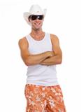 Portrait of on vacation smiling young man in sunglasses and hat
