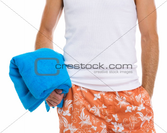 Closeup on happy guy holding blue towel