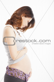 asian pregnant woman caressing her belly 