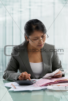 Asian businesswoman checking bills