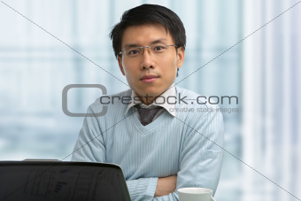 Young Chinese male working in office