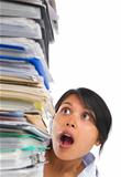 Asian lady surprised by high pile of paperwork