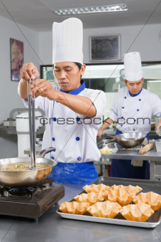 Chef preparing the fried wheat bowl